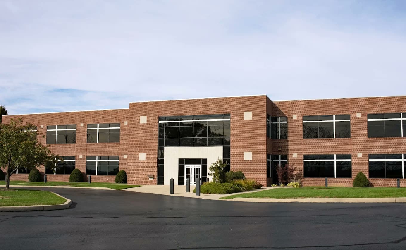 Two-story brick commercial office building with a glass entrance