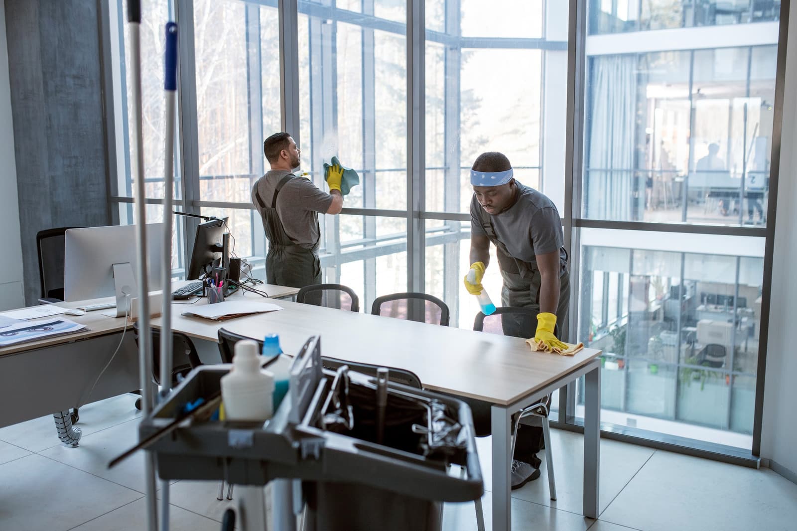 Two-person janitorial crew cleaning a commercial facility