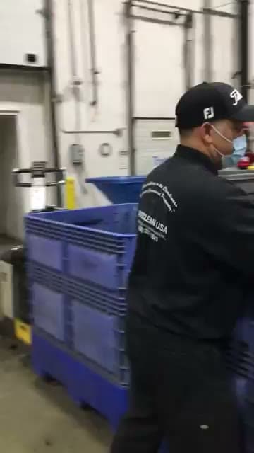 ProClean USA crew member handling waste at a distribution center dock