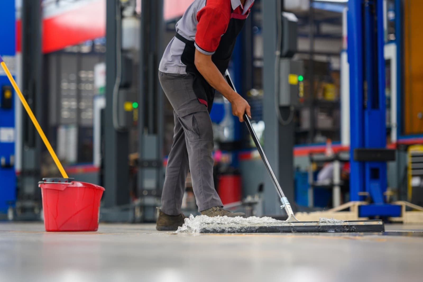 Worker mopping the floor of an industrial facility